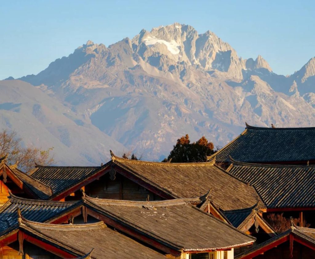 Jade Dragon Snow Mountain in Lijiang roofs of Yunnan